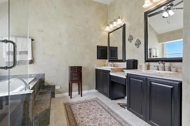 a spacious bathroom with a double vanity sink and a mirror