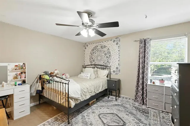 a bedroom with a bed and a chandelier