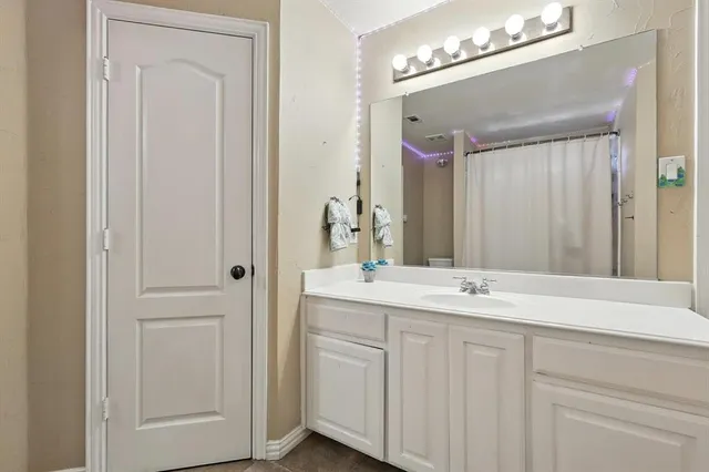 a bathroom with a double vanity sink and a mirror