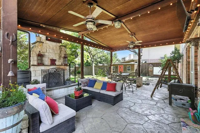 a living room with patio furniture and a chandelier