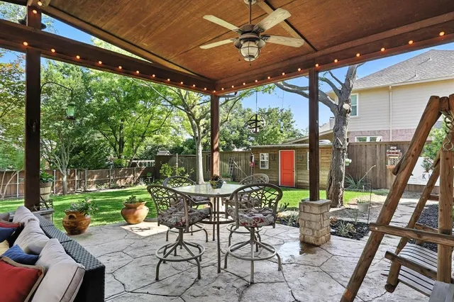 a view of a patio with a table chairs and a backyard