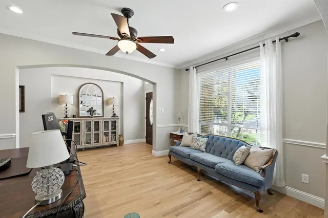 a living room with furniture ceiling fan and a rug