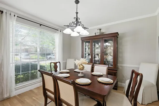 a view of a dining room with furniture wooden floor and chandelier