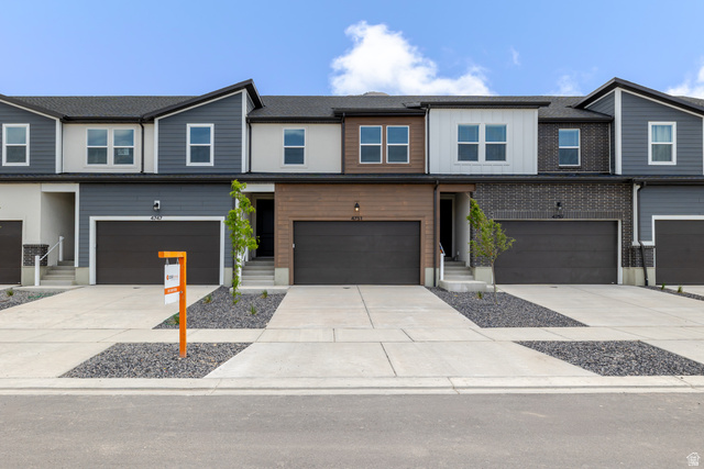 4751 Olive Avenue, Unit 408 Mapleton, UT 84664 - Photo 1 of 5 View of front facade featuring concrete driveway, board and batten siding, a garage, and entry steps