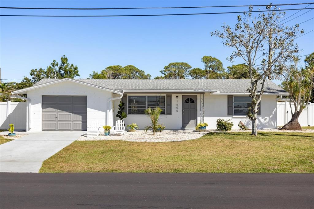 a view of a house with swimming pool and sitting area