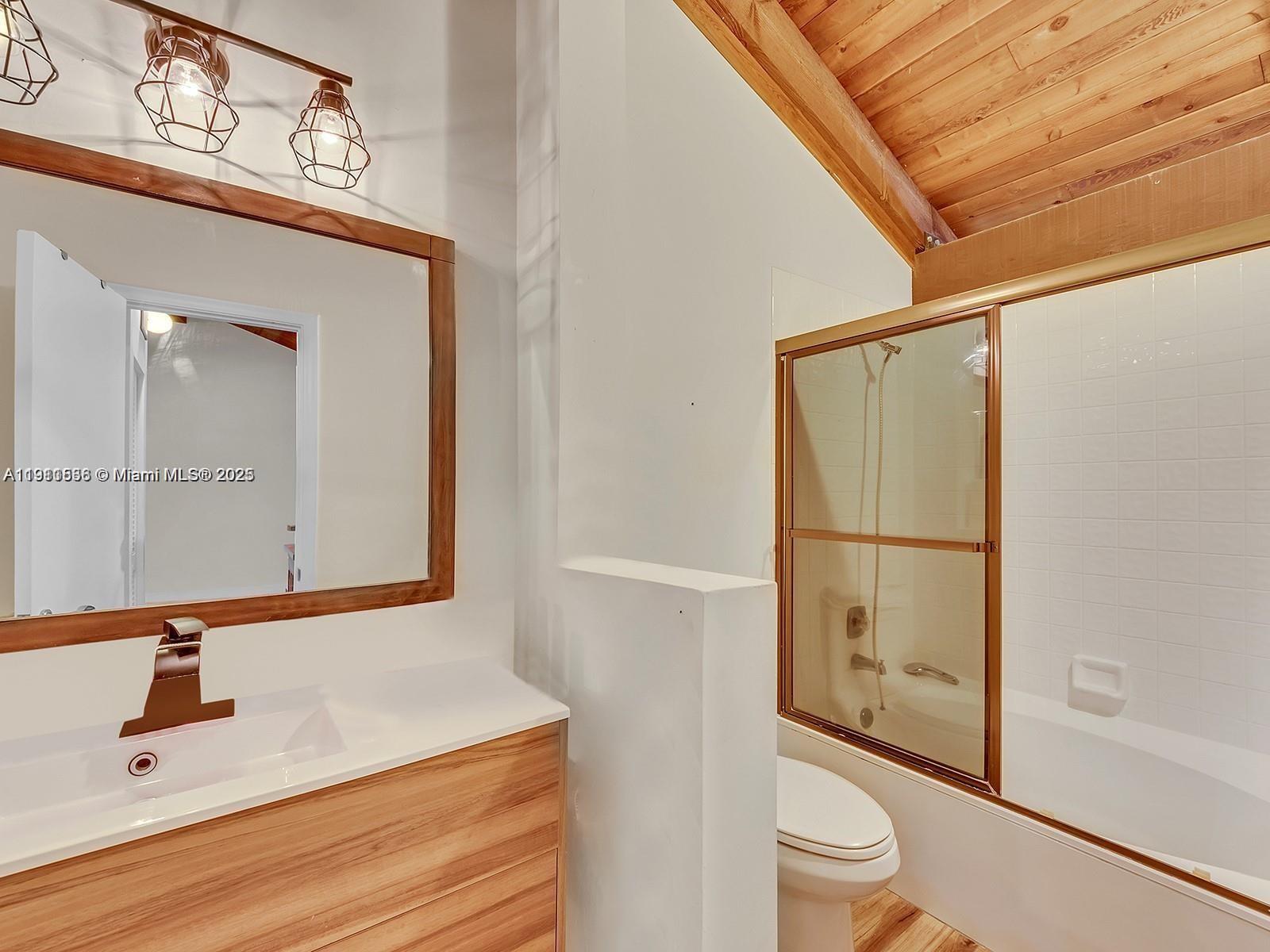 2701 Southwest 58th Manor, Unit B Dania Beach, FL 33312 - Photo 12 of 18 a bathroom with a sink a toilet and shower