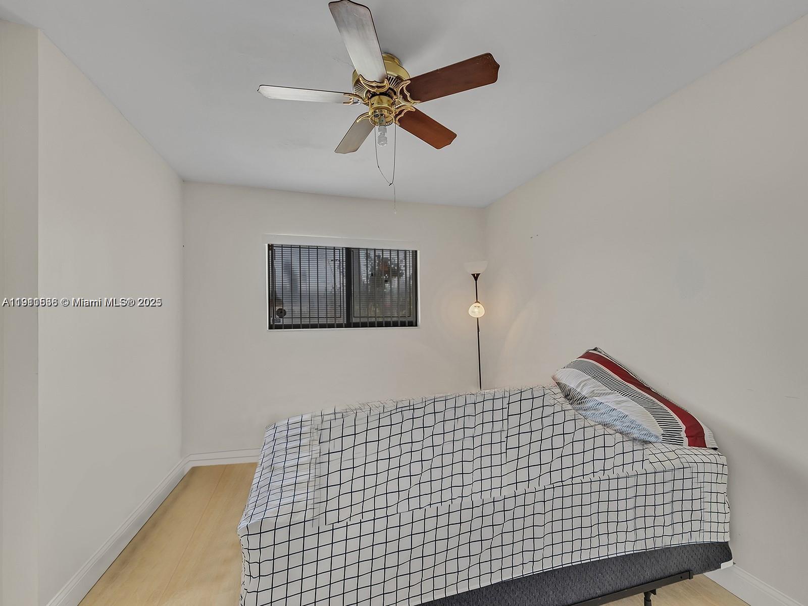 2701 Southwest 58th Manor, Unit B Dania Beach, FL 33312 - Photo 13 of 18 a bedroom with a bed and a ceiling fan