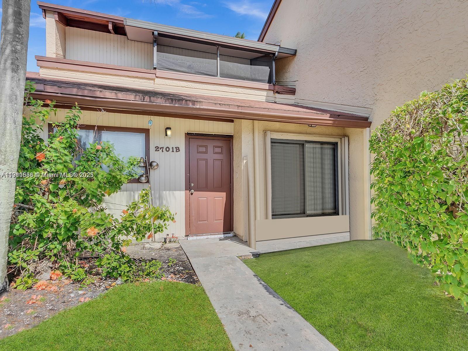 2701 Southwest 58th Manor, Unit B Dania Beach, FL 33312 - Photo 17 of 18 front view of a house with a small yard