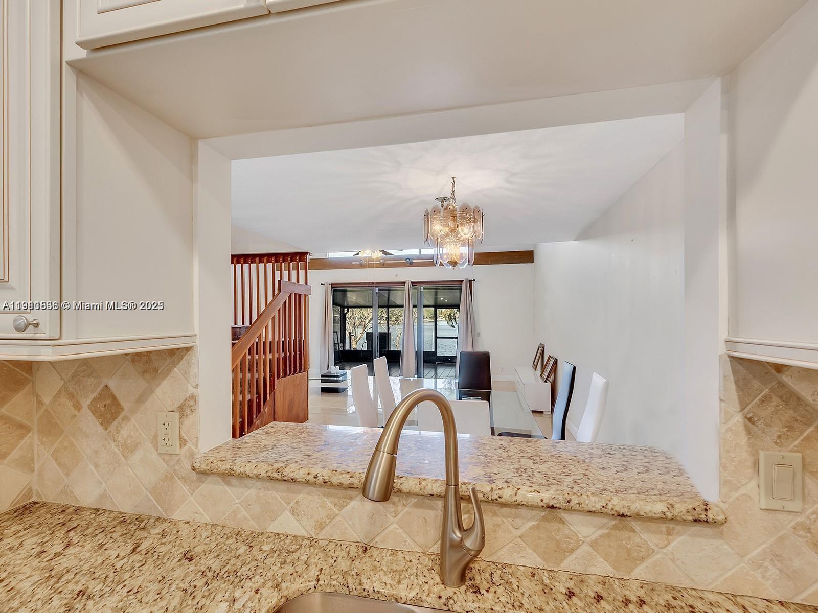 2701 Southwest 58th Manor, Unit B Dania Beach, FL 33312 - Photo 9 of 18 a dining room with furniture and chandelier