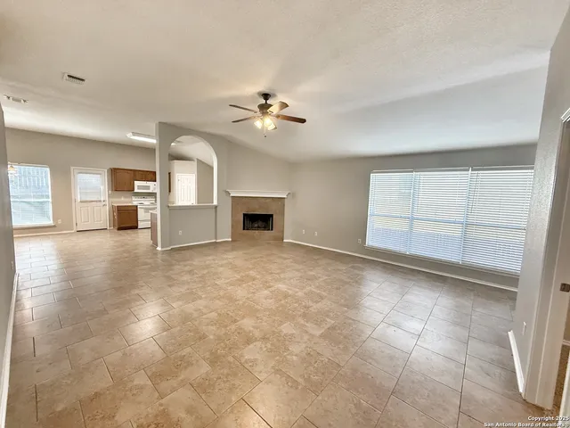 a view of a room with cabinet and a ceiling fan