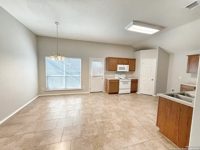 a view of kitchen with microwave and cabinets