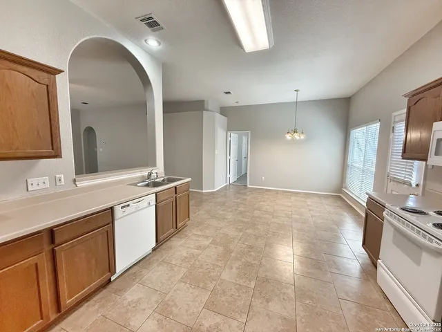 a large bathroom with a large mirror vanity and shower
