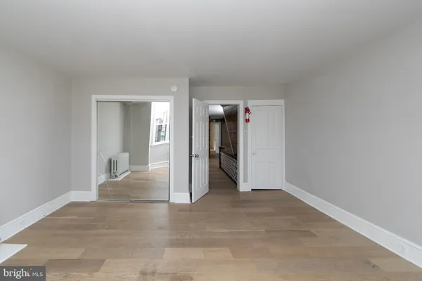 a view of a big room with closet and chandelier fan