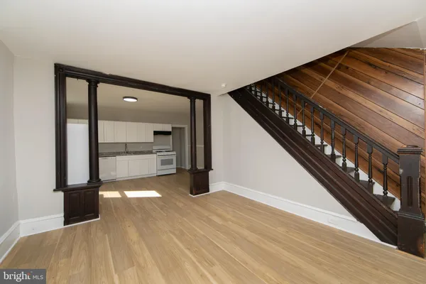 a view of an empty room with wooden floor