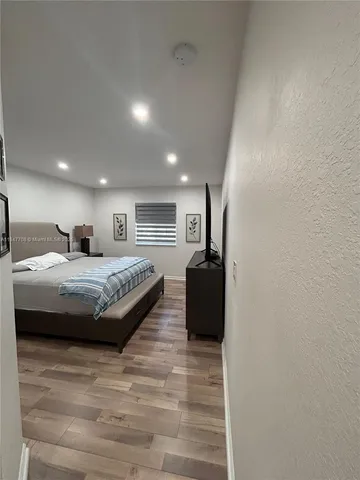 a bed room with a bed and a large window