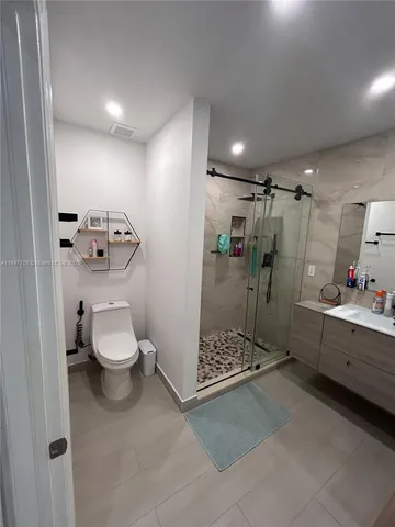 a bathroom with a toilet and a shower