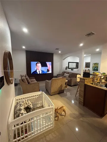 a living room with furniture flat screen tv and a fireplace