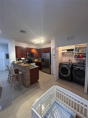 a kitchen with a refrigerator and a sink