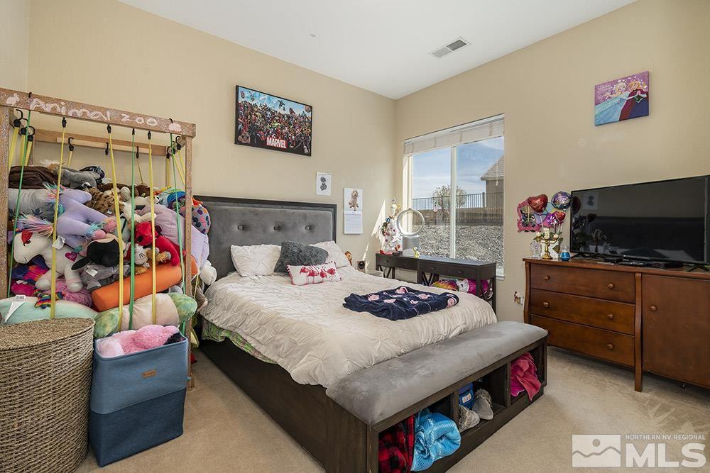 6840 Marble Canyon Road Reno, NV 89511 - Photo 13 of 39 a bedroom with a bed and a window