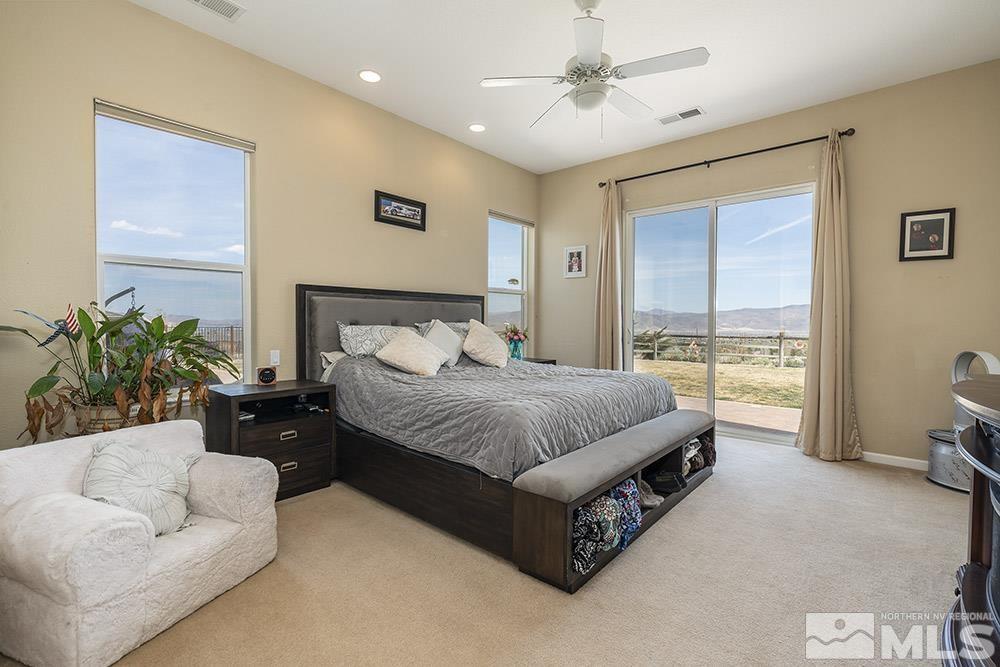 6840 Marble Canyon Road Reno, NV 89511 - Photo 14 of 39 a spacious bedroom with a bed and a couch
