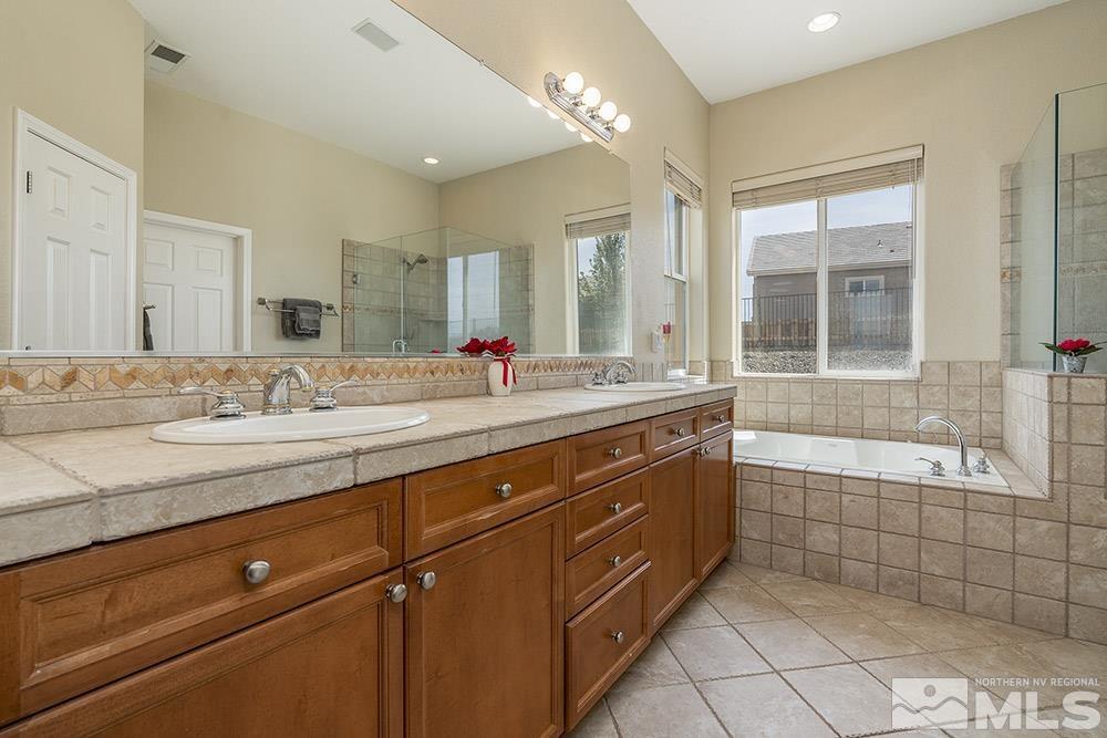 6840 Marble Canyon Road Reno, NV 89511 - Photo 15 of 39 a bathroom with a granite countertop sink mirror bathtub and double