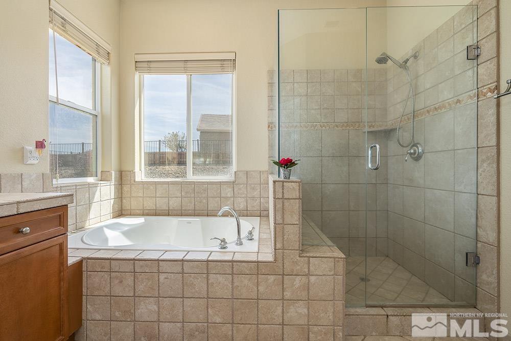 6840 Marble Canyon Road Reno, NV 89511 - Photo 16 of 39 a bathroom with a shower and a bathtub