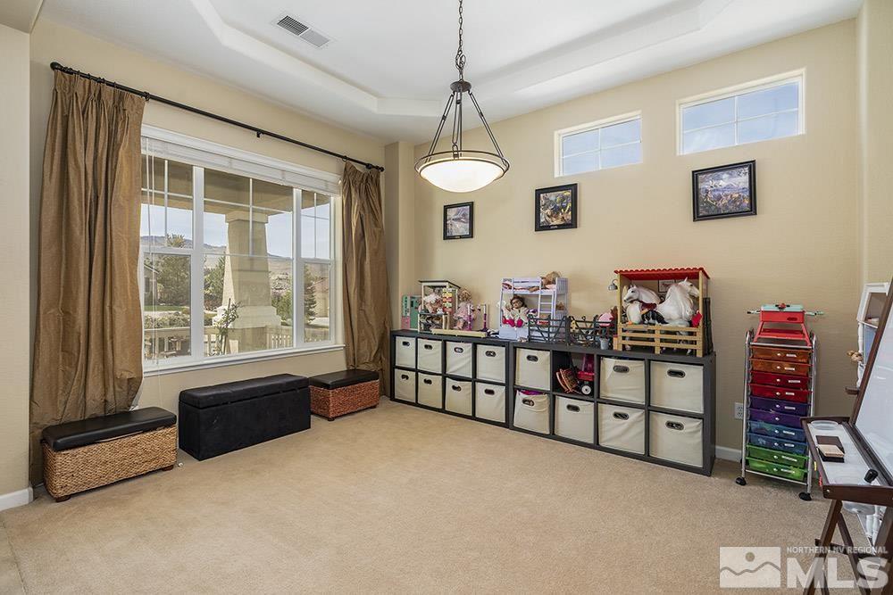 6840 Marble Canyon Road Reno, NV 89511 - Photo 3 of 39 a livingroom with toys and a chandelier