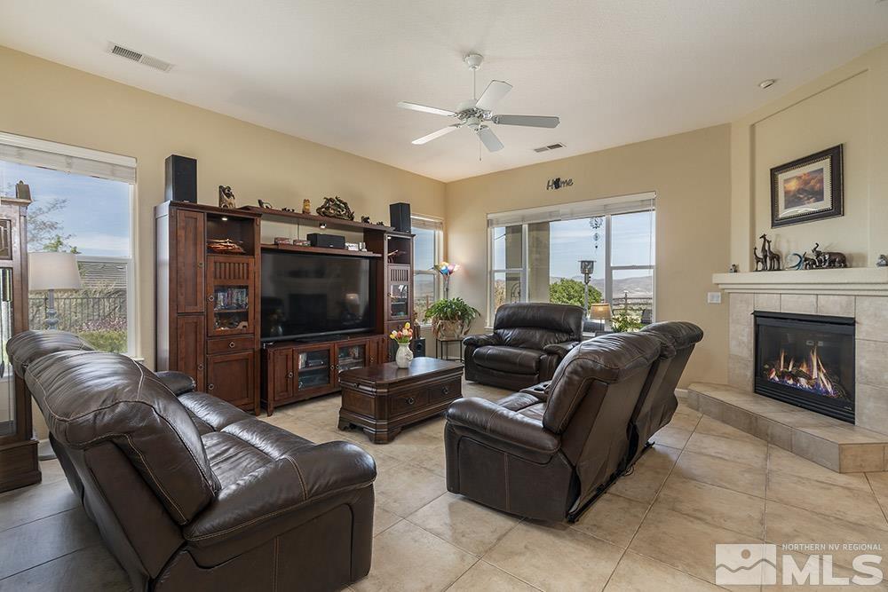 6840 Marble Canyon Road Reno, NV 89511 - Photo 5 of 39 a living room with furniture and a flat screen tv