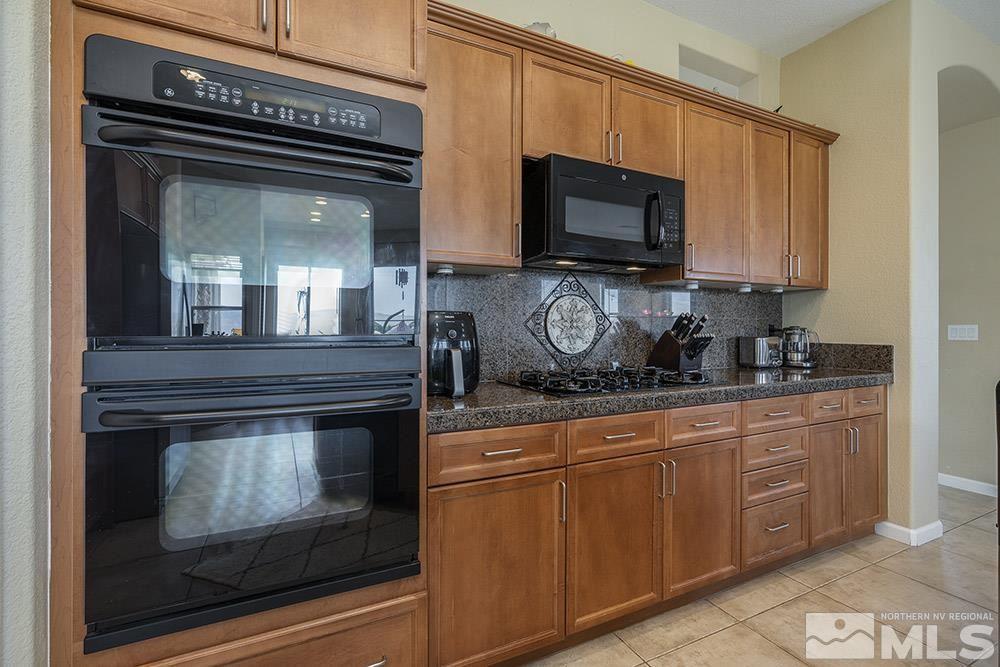 6840 Marble Canyon Road Reno, NV 89511 - Photo 8 of 39 a stove top oven sitting inside of a kitchen