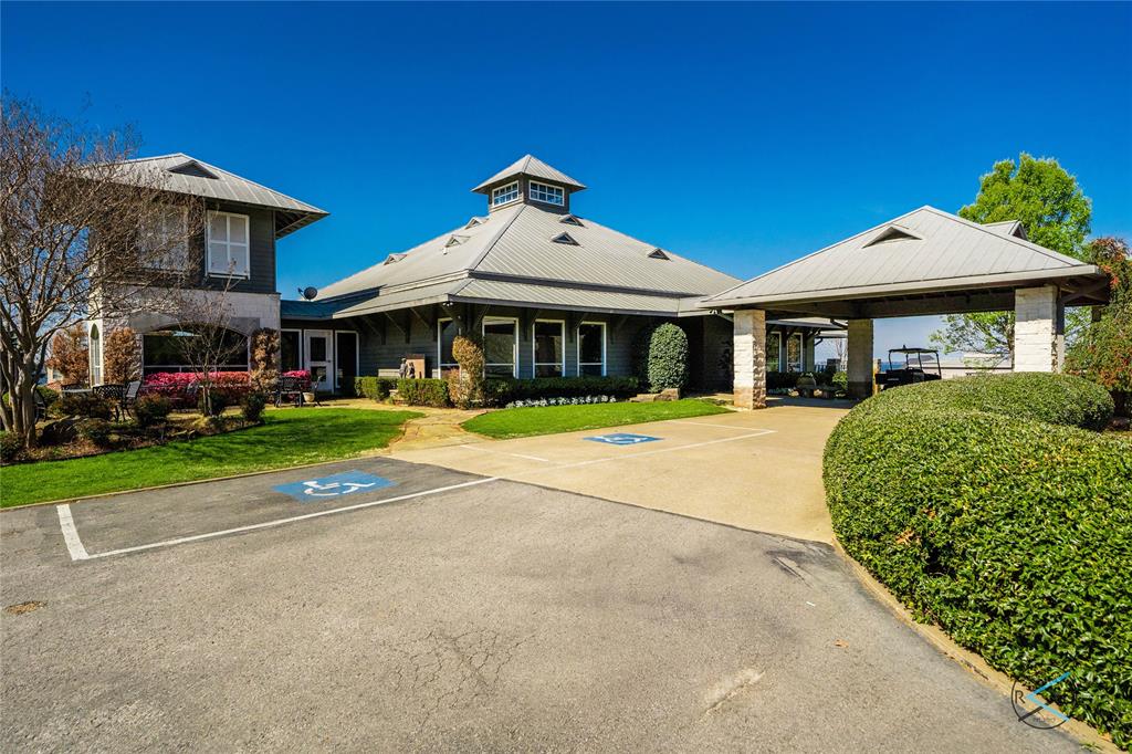 237 Colonial Drive Mabank, TX 75156 - Photo 17 of 20 a front view of a building with a garden and plants