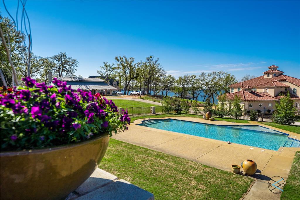 237 Colonial Drive Mabank, TX 75156 - Photo 9 of 20 a view of a garden with flowers and large trees