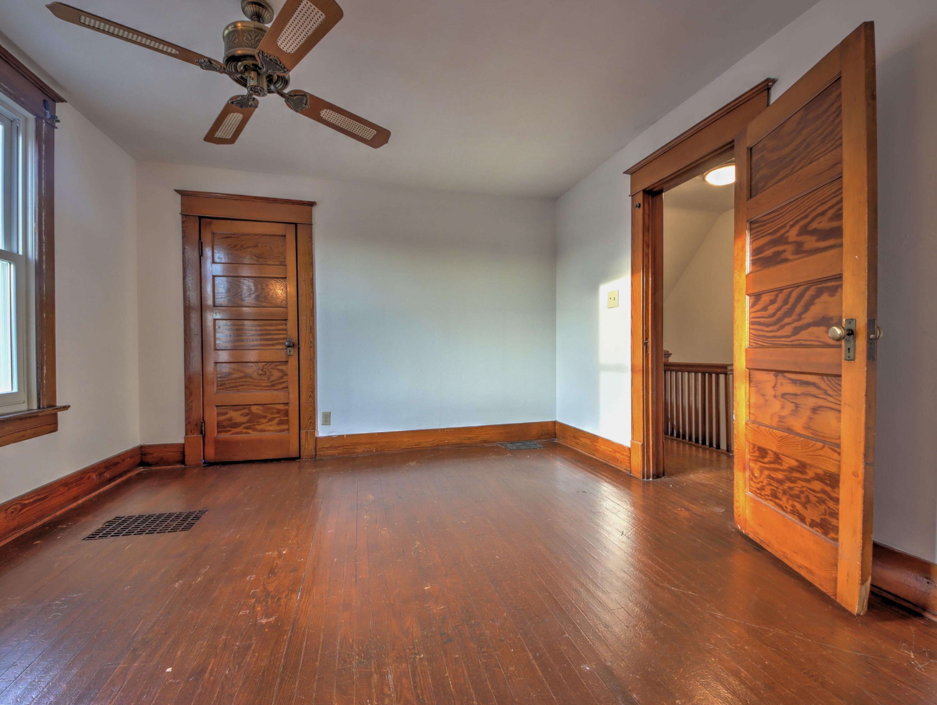 119 Patton Street La Porte, IN 46350 - Photo 15 of 26 a view of an empty room with a window and wooden floor