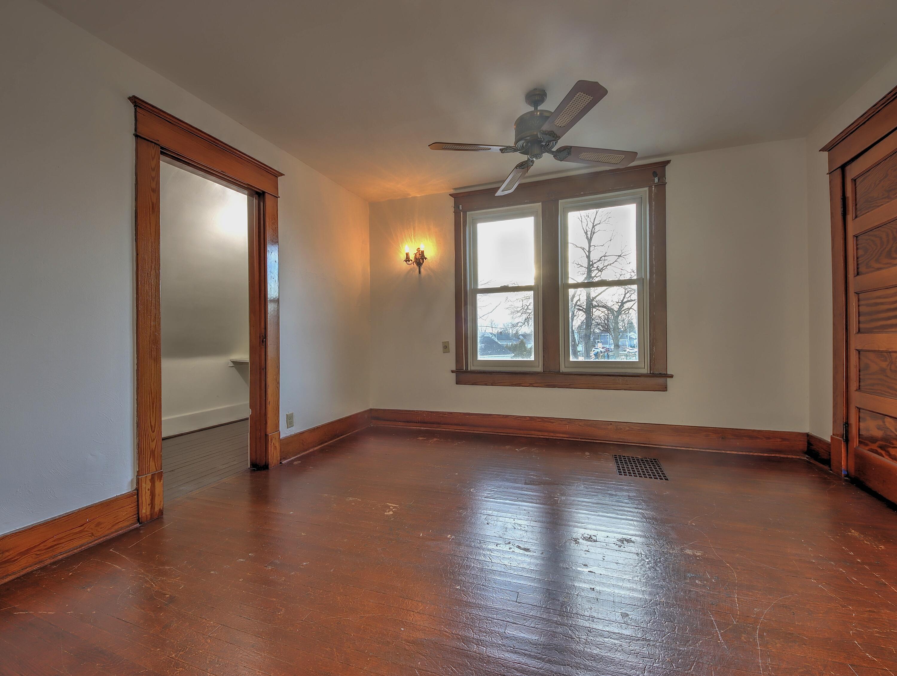 119 Patton Street La Porte, IN 46350 - Photo 16 of 26 an empty room with wooden floor closet and windows