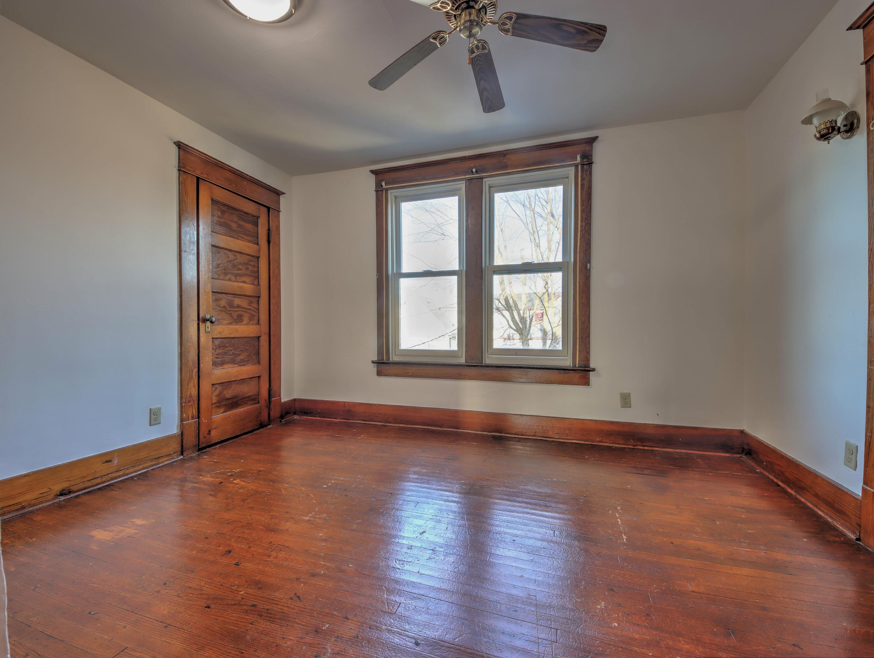119 Patton Street La Porte, IN 46350 - Photo 17 of 26 a view of an empty room with a window and wooden floor