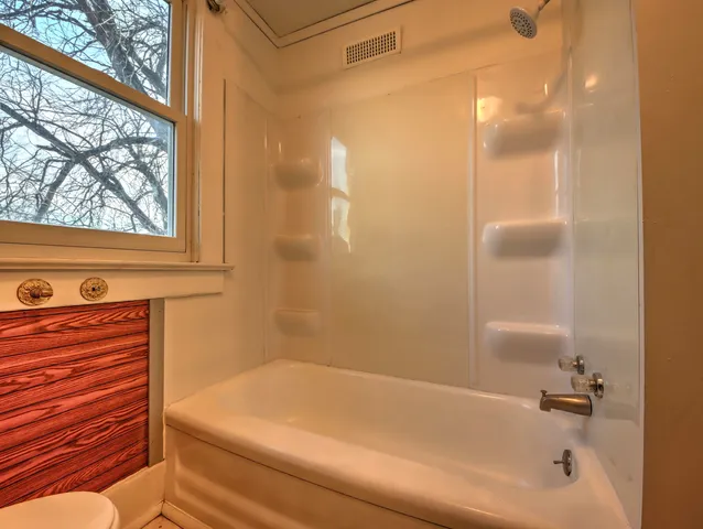 a bathroom with a bathtub and shower