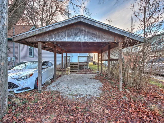 a wooden bench sitting in front of a house