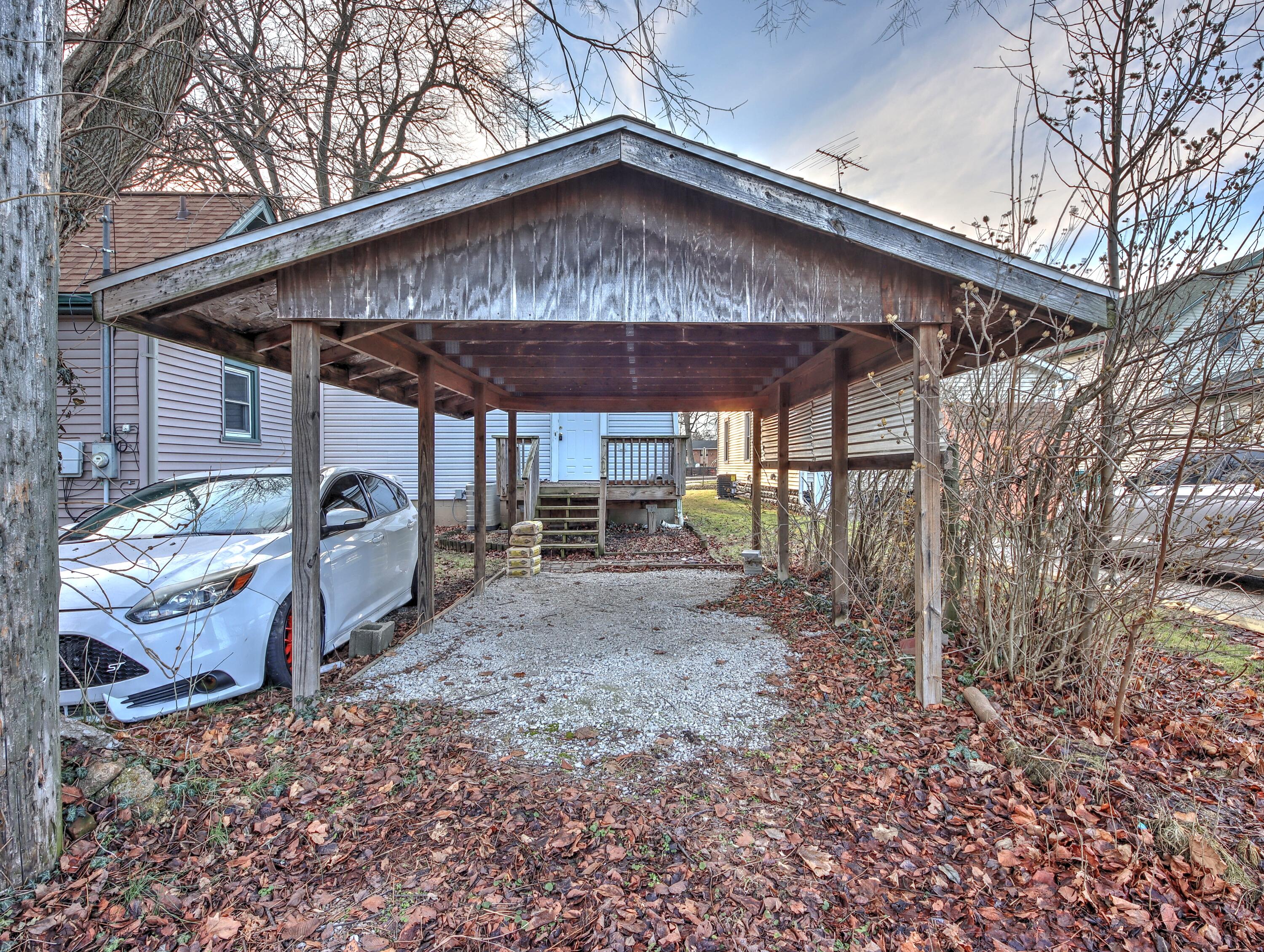 119 Patton Street La Porte, IN 46350 - Photo 26 of 26 a wooden bench sitting in front of a house