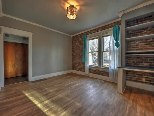 wooden floor in an empty room with a window
