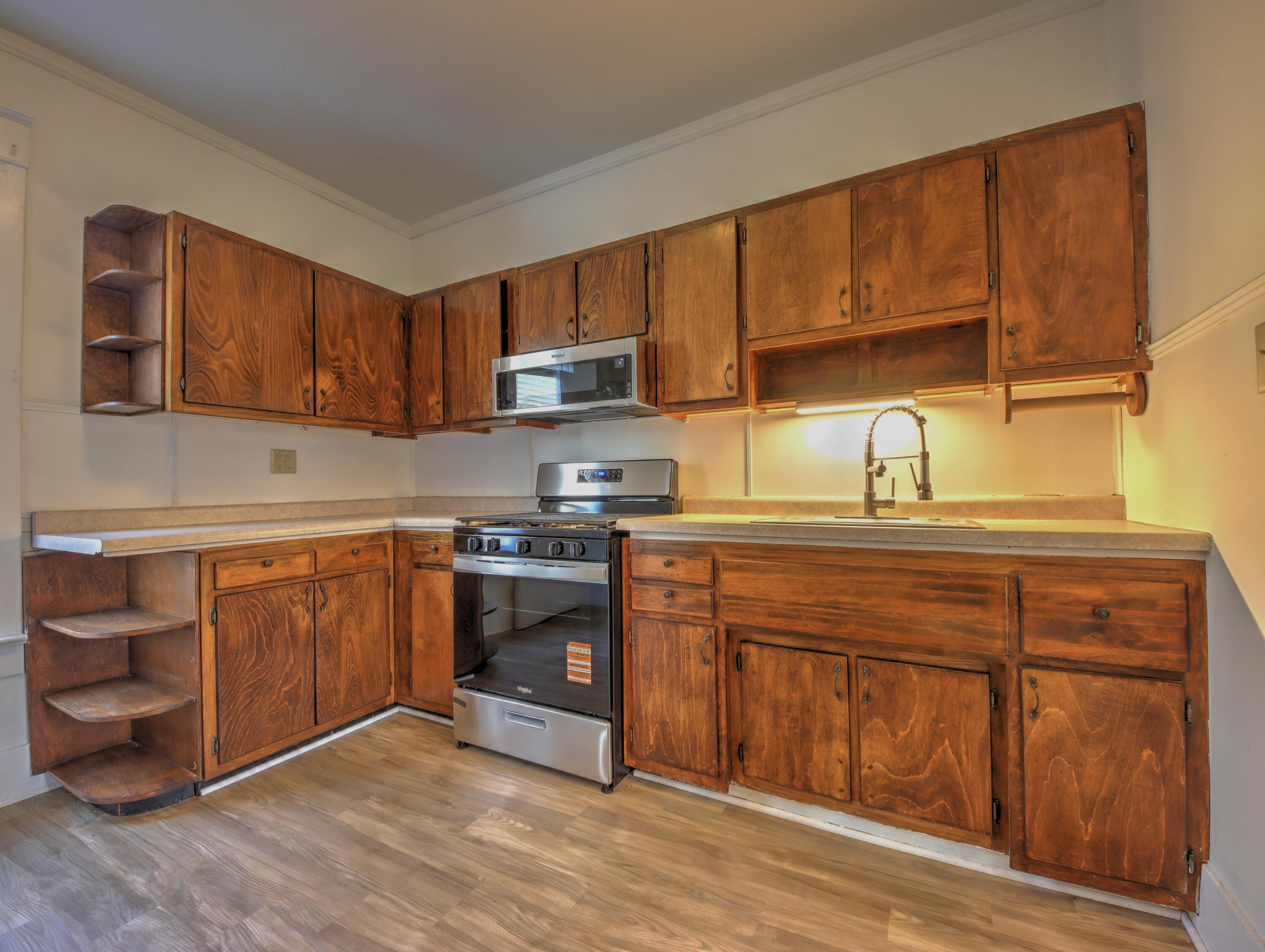 119 Patton Street La Porte, IN 46350 - Photo 8 of 26 a kitchen with stainless steel appliances granite countertop a stove a sink dishwasher and a microwave oven with cabinets