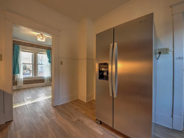 a view of a hallway with wooden floor