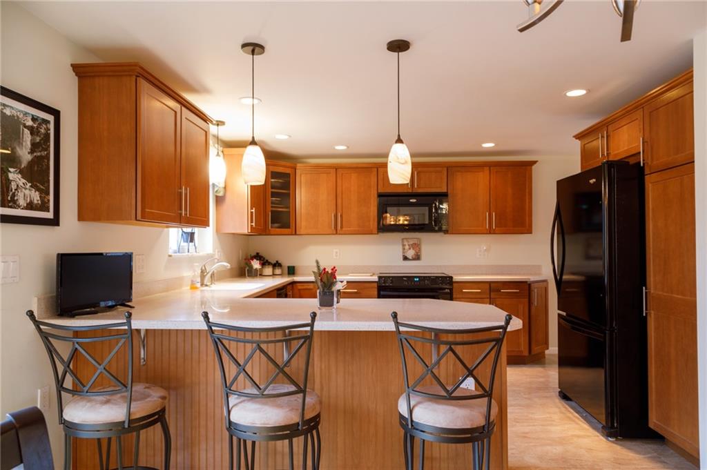 9415 Pannier Road Pittsburgh, PA 15237 - Photo 7 of 25 Kitchen with cherry cabinets, quartz countertops, breakfast bar
