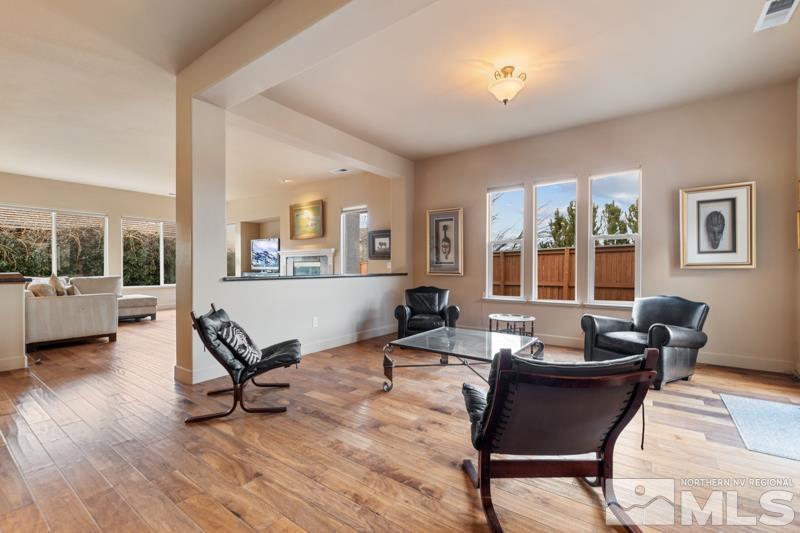1630 Brightstone Court Reno, NV 89521 - Photo 4 of 27 a living room with furniture a flat screen tv and a large window