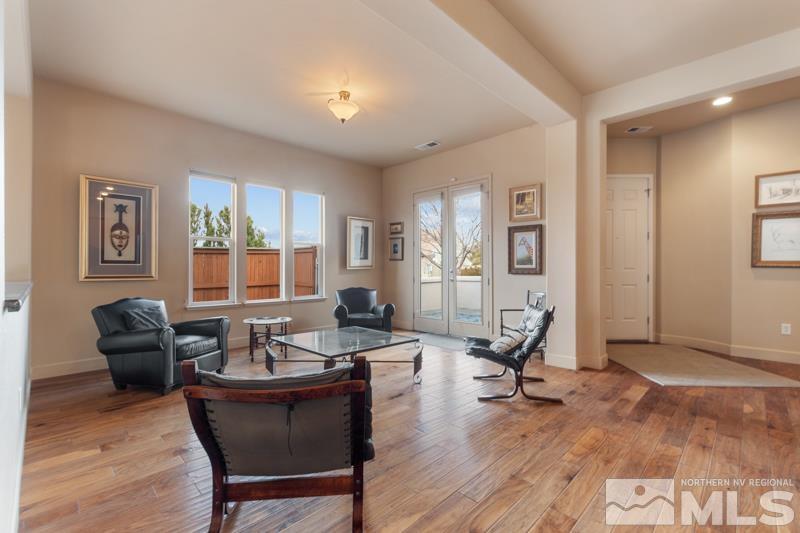 1630 Brightstone Court Reno, NV 89521 - Photo 8 of 27 a living room with furniture a wooden floor and a large window
