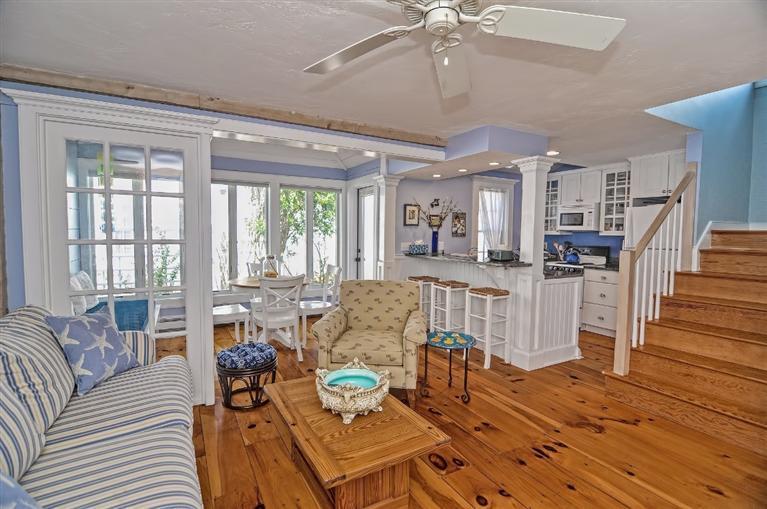 a living room with furniture dining table and a large window