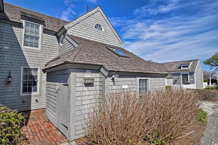 7 Hyannis Point Road, Unit 771HY Mashpee, MA 02649 - Photo 12 of 14 a front view of a house with a yard
