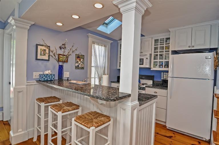 7 Hyannis Point Road, Unit 771HY Mashpee, MA 02649 - Photo 4 of 14 a kitchen with granite countertop cabinets and refrigerator