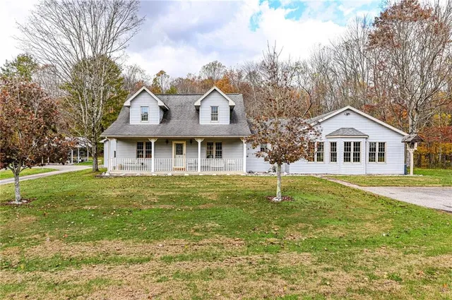 a front view of a house with a garden