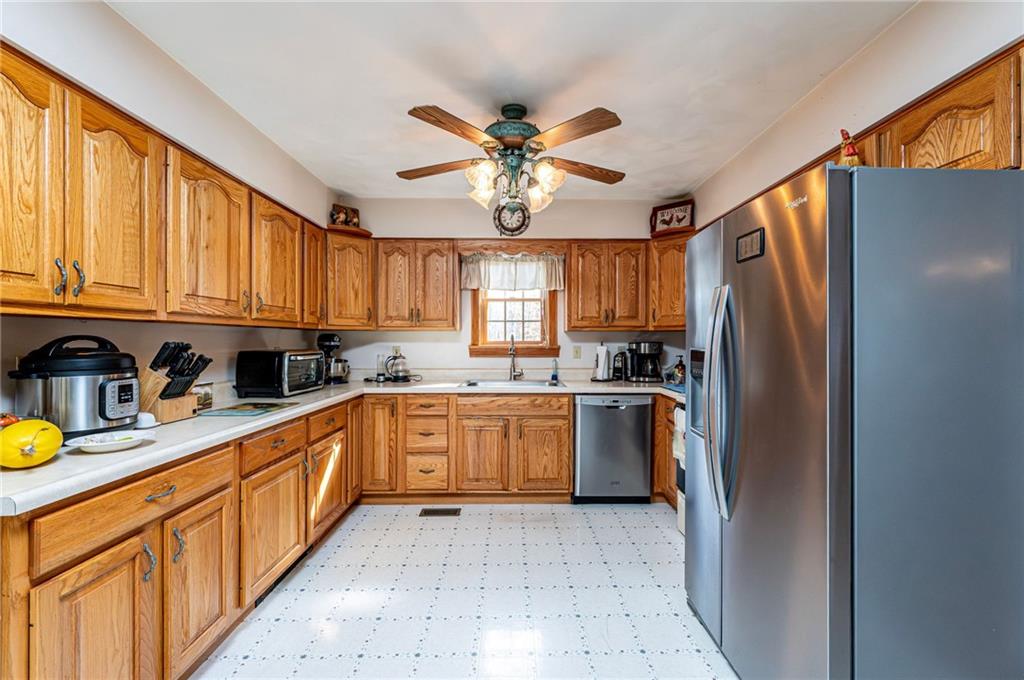 120 Youngstown Ridge Road Ligonier, PA 15658 - Photo 15 of 50 a kitchen with stainless steel appliances granite countertop a refrigerator a stove top oven a sink and dishwasher