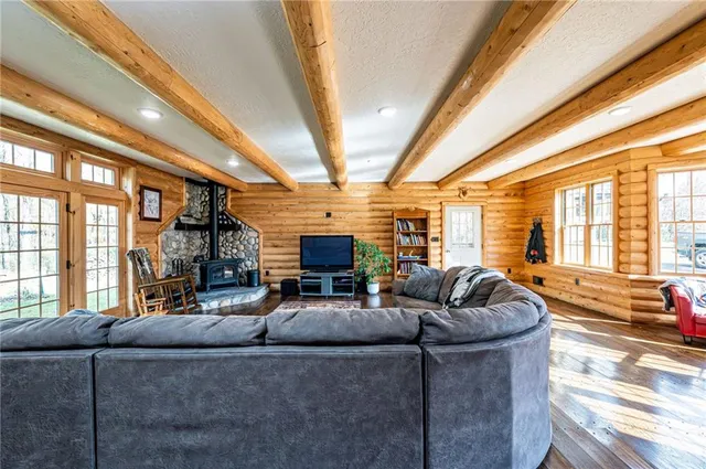a living room with furniture a fireplace and a large window