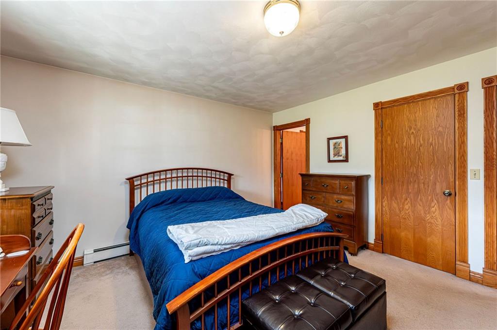 120 Youngstown Ridge Road Ligonier, PA 15658 - Photo 26 of 50 a bedroom with a bed and wooden floor